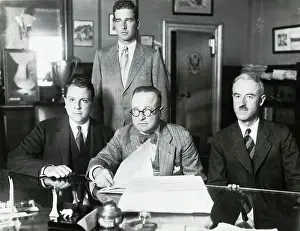 Men Sitting and Standing in Office