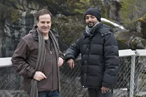 Warm Clothing Prints: Two Men Standing At A Fenced Lookout Point With Moss Covered Rock In The Background In Jasper National Park