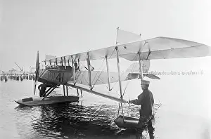 Floating Prints: Men Standing In Water W/Early Seaplane