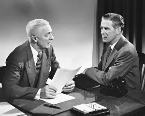 Necktie Prints: Two men talking, one holding paper