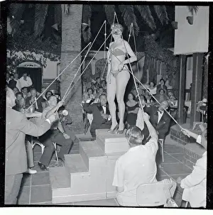 Men Trying to Unhook a Woman's Bathing Suit