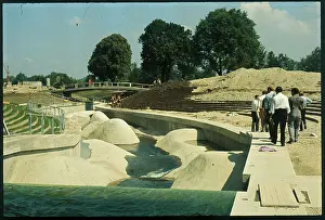 Men Walking by Olympic Slalom Obstacle