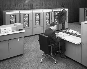 Typing Prints: Two Men Working with Early Mainframe Computer