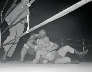Men Wrestling by the Ropes