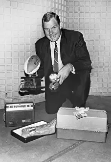 Merlin Olsen Posing with Trophies