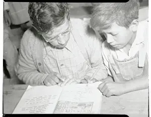 Mexican Parent and Son Reading from Book