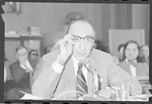 Michael E Prints: Michael E. DeBakey Adjusting Eyeglasses at Health Meeting