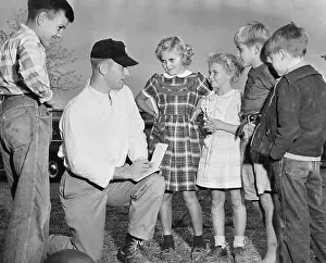Mickey Mantle Giving Young Fans His Autograph