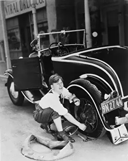 Mickey Rooney Working with Car Tire