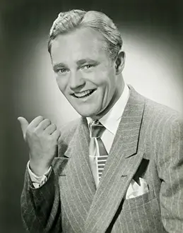 Thumbs Up Prints: Mid adult man gesturing, portrait
