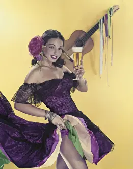 Off Shoulder Prints: Mid adult woman holding glass of beer with guitar in background