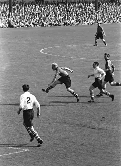 Prints of Wolverhampton Wanderers captain Billy Wrightin action during a match against Middlesbrough. Original Publication: Picture Post - 4884 - Are Wolves The Team Of The Season - pub A Photographic Legacy: Mid Match