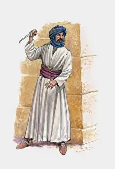 Middle eastern man standing near wall holding knife