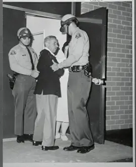 Mike Romanoff Being Escorted by Police