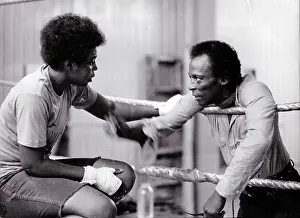 Prints of NEW YORK - CIRCA 1980: Miles Davis talks to a female boxer circa 1980 in New York City. (Photo by PaL Gould/Images/Getty Images) In the Ring: The Art of Boxing: Miles Davis