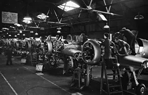 Prints of 10th January 1942: The production line making Miles Master II trainer aircraft for the RAF. Original Publication: Picture Post - 952 - A Girl Goes Into War Industry - pub Discover the Vision of Haywood Magee – A Master of Mid-Century British Life: Miles Masters