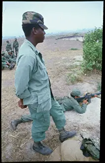 Military Advisor Checking Salvadorean Cadet at Firing Practice