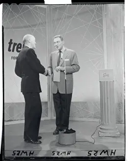 Military Officer Shaking Hand of Jack Barry at Microphone