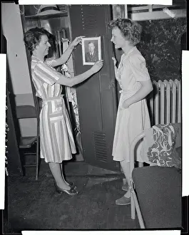 Des Moines Prints: Military Women Hanging Portraits on Wall