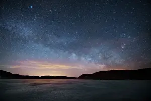 Milky Way floats above frozen lake, Front Range, Colorado, USA