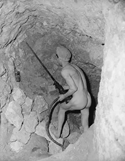 A Miner Using a Drill