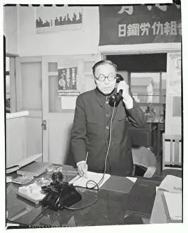 Minoru Takano Talking on Phone