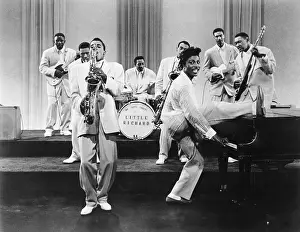 Prints of CIRCA 1957: Musician Little Richard performs onstage with his band as his saxophone player Grady Gaines stands on the piano in circa 1957 in scene from the movie Mister Rock And Roll The Architect of Rock: Mister Rock And Roll Film Still