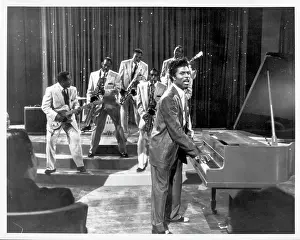 Prints of CIRCA 1957: Musician Little Richard performs onstage with his band as his saxophone player Grady Gaines stands on the piano in circa 1957 in scene from the movie Mister Rock And Roll The Architect of Rock: Mister Rock And Roll Film Still