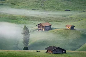 Misty landscape view in Alpe di Siusi or Seiser Alm at beautiful sunrise