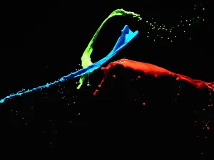 Prints of Red, blue and green splashes on black background Stone Prints: Mixing Liquids