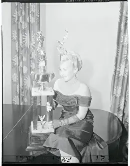 Model, Ann Rush Posing With Trophy