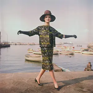 Model Posing in Abstract Print Ensemble with Hat and Gloves