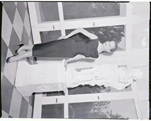 Model Posing by Large Statue