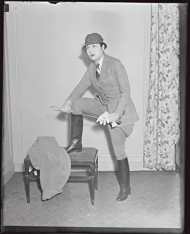 Model Posing with Propped Leg in Riding Suit