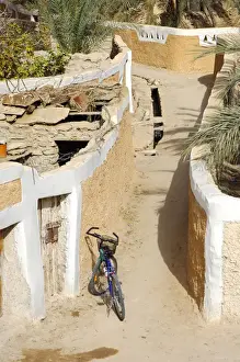Parking Prints: Modern bike parking in a lane in the Old town of Ghadames, UNESCO world heritage, Libya