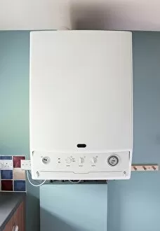 Modern boiler on blue wall in domestic kitchen