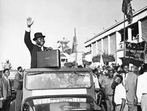 Jeep Prints: Moise Tshombe On Jeep Holding Briefcase