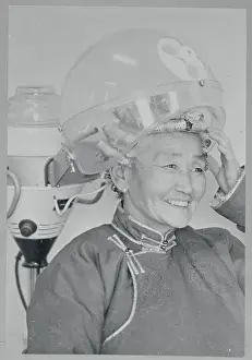 Mongolian Woman Smiling Underneath Hair Dryer
