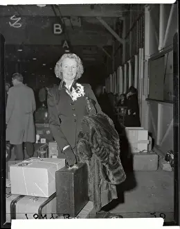 Monica Dickens Standing with Her Luggage