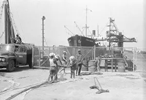 Monrovia Prints: Monrovia Dock Workers near Large Ship