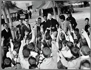Monsignor John Roudan Surrounded by Young People