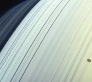Moon (Mimas) orbiting Saturns northern latitudes, satellite view