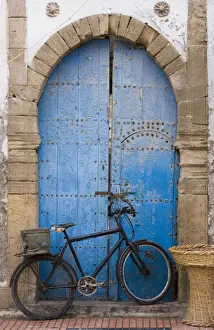 Alluring Doorway Prints: Morocco, Essaouira, bicycle propped against blue painted door
