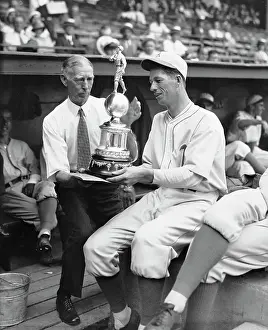 Pitcher Prints: Moses Grove Shows Trophy To Connie Mack