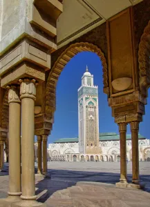 Morocco, North Africa Prints: Mosque of Hassan II and minaret through the arches of the square outside it in Casablanca
