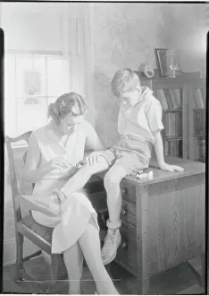 Mother Applying Ointment to Knee