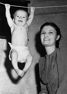 6 11 Months Prints: Mother with baby boy (6-11 months) hanging on rope