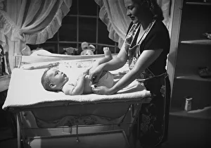 Changing Gallery: Mother changing babys (3-6 months) nappy, (B&W)