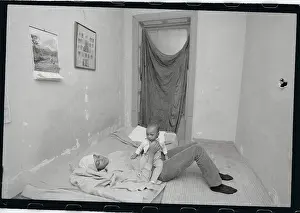 Scarcity Prints: Mother and Child Playing in Poorly Furnished Bedroom