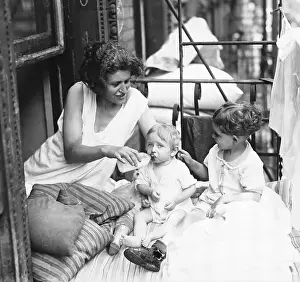 Mother With Her Children On Fire Escape